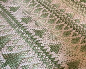 crochet blanket with white and green trees