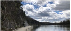 sky with cloads and a walking wooden ramp and water with reflection of the sky