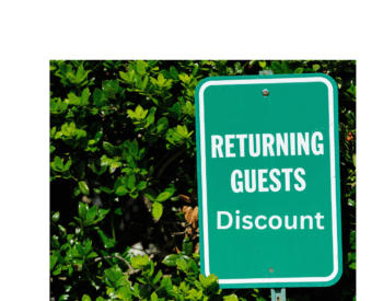 A Green Sign that says return guest discount with foliage in the backgound