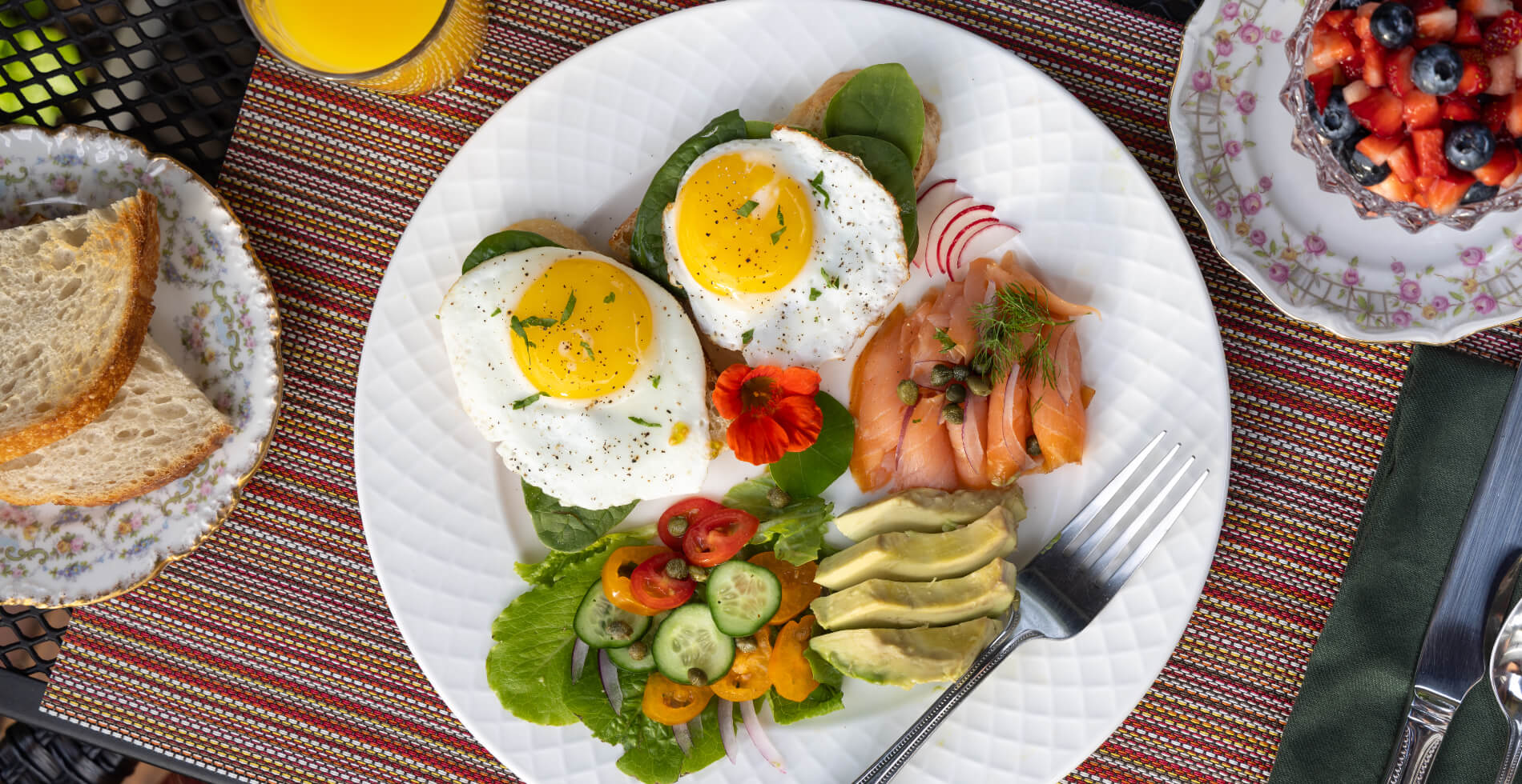 vibrant mixed salad with an array of green vegetables, topped with guacamole and tomatoes