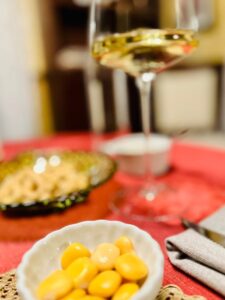 glass of white wine and lupini beans 