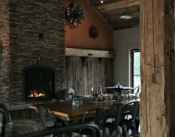 Interior view of the cornucopia café, a brown rustic design with a floor to ceiling stone fireplace.